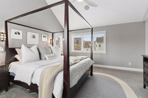 Spacious primary suite with vaulted ceilings and three sides of large windows. A peaceful retreat filled with natural light.