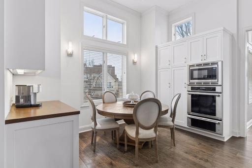 Sun-filled dining area with tall windows, built-in cabinetry, and easy access to the kitchen.