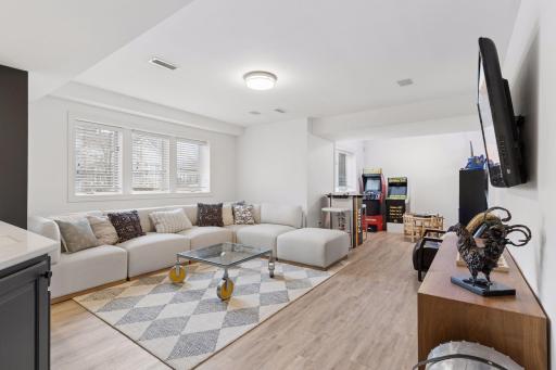 Fun and functional lower level recreation space with room for games, hobbies, or movie nights. Durable flooring and built-in storage make it perfect for everyday use