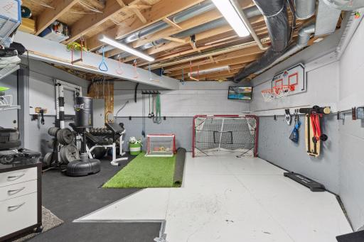 Almost everything-proof lower level flex space with commercial grade rubber flooring. Let the pucks fly, kick soccer balls, lift weights, or practice your ninja skills. Two nice storage rooms attached.