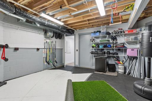 Almost everything-proof lower level flex space with commercial grade rubber flooring. Let the pucks fly, kick soccer balls, lift weights, or practice your ninja skills. Two nice storage rooms attached.