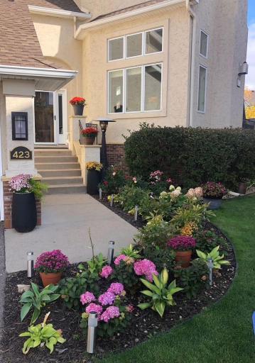 Inviting front entry framed by mature landscaping and elegant architectural details