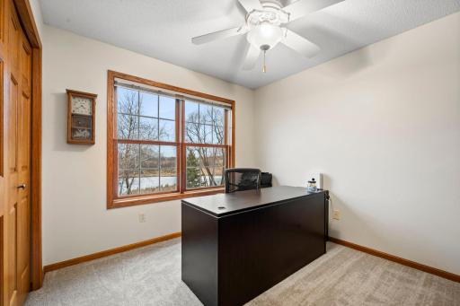 Bedroom 3 on the main level has French doors and a view of the private backyard.