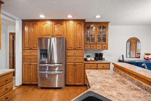 The kitchen has a wall of cabinetry for storage.
