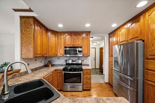 Stainless steel appliances and a gas stove in the kitchen are modern and functional.