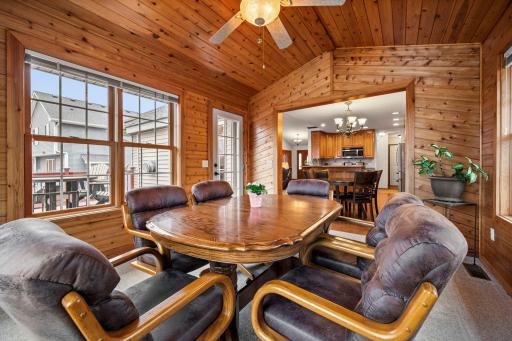 The 4-season porch is filled with windows and overlooks a pond in the backyard.