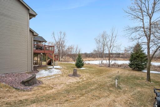 The yard is well-maintained with retaining walls on the sides of the house.