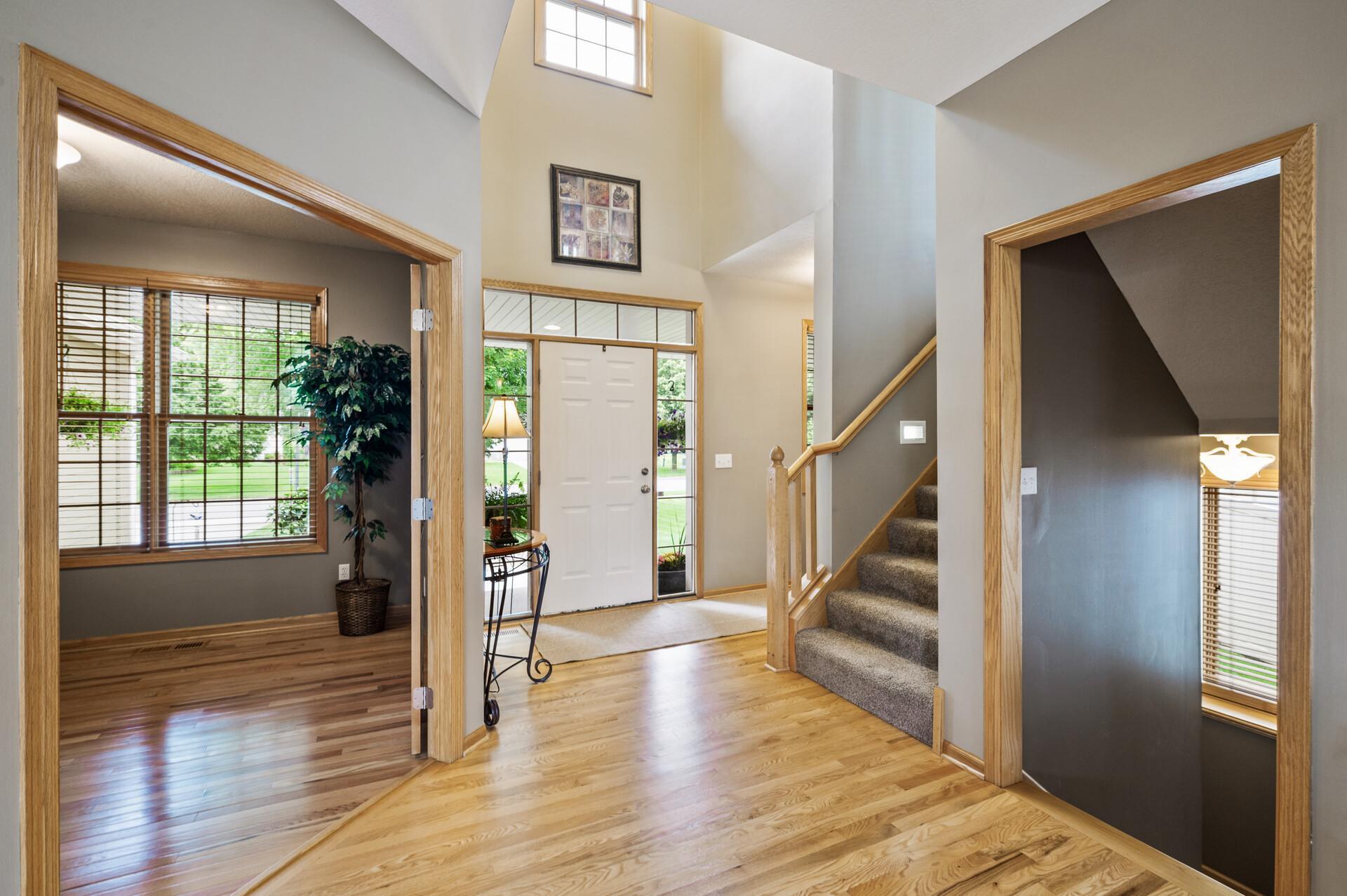 Warm wood floors welcome you in, setting the tone for a space that feels both inviting and timeless from the very first step.