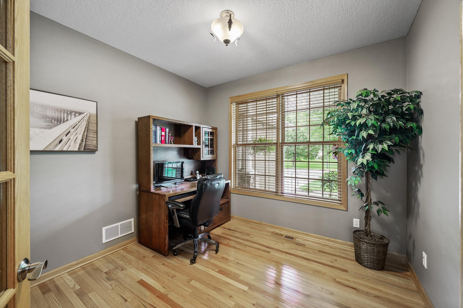 Working from home in private office, large windows and stunning hardwood floors.