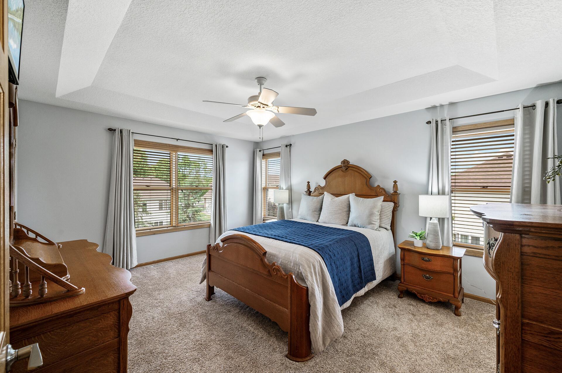 Primary suite drenched in natural sunlight, expansive windows.