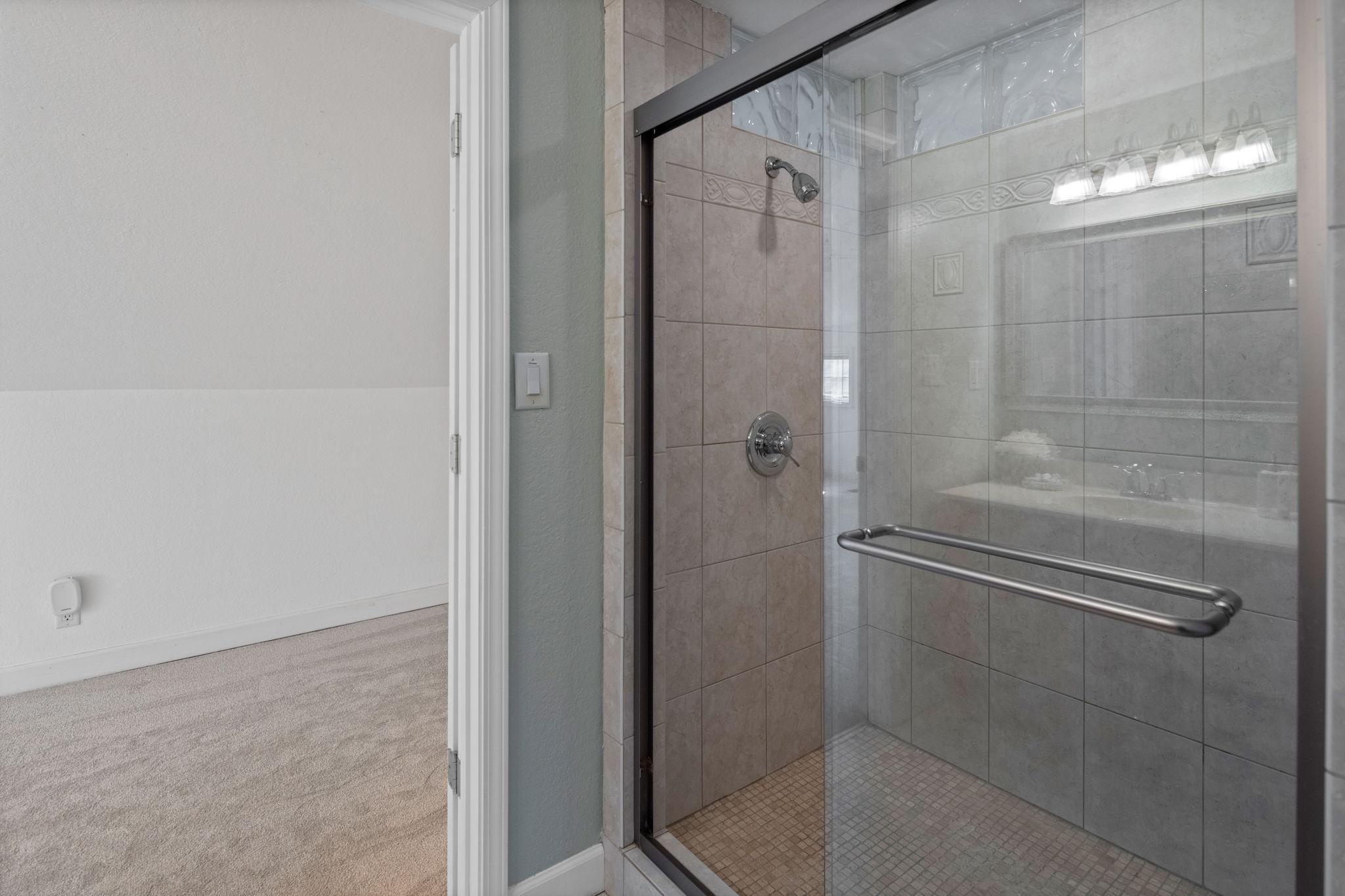 Primary suite tile shower.