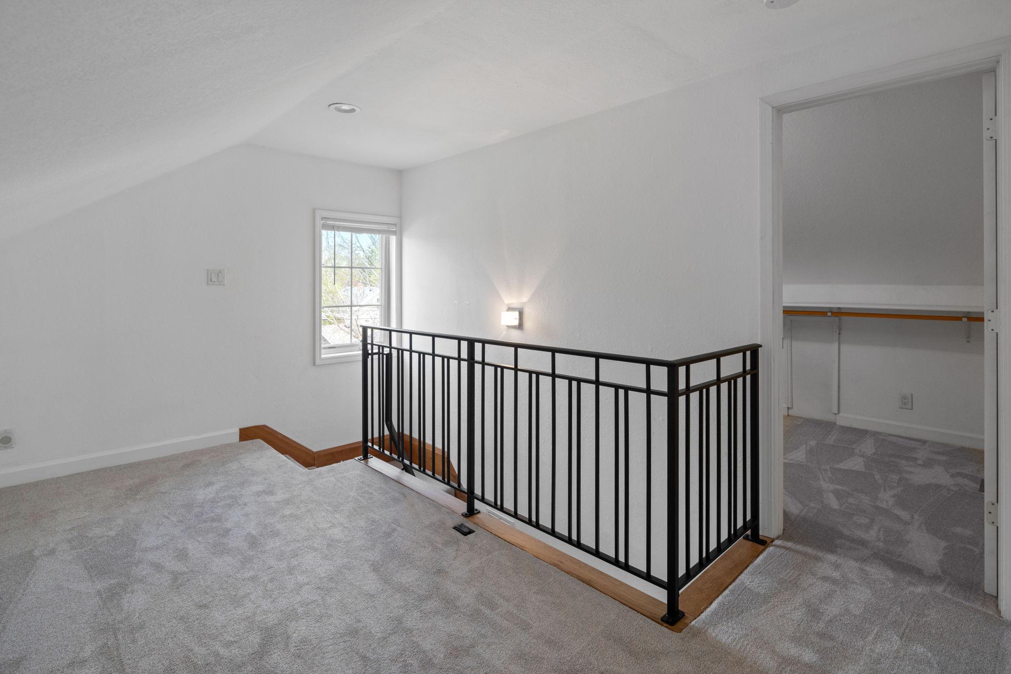 Upper level primary suite is private and tucked away.