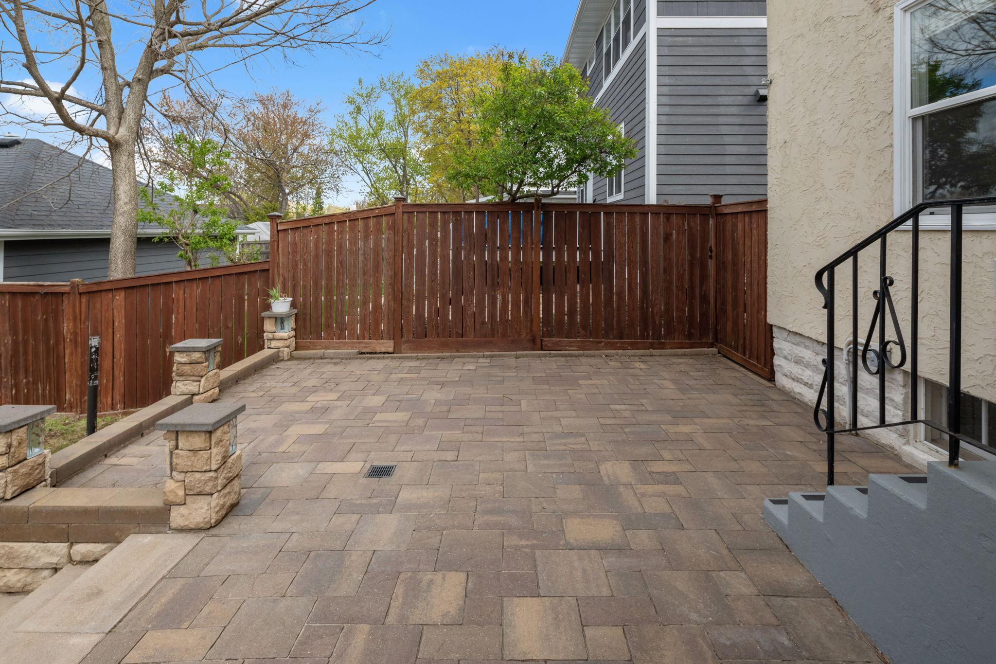 Paver patio and wood fence.