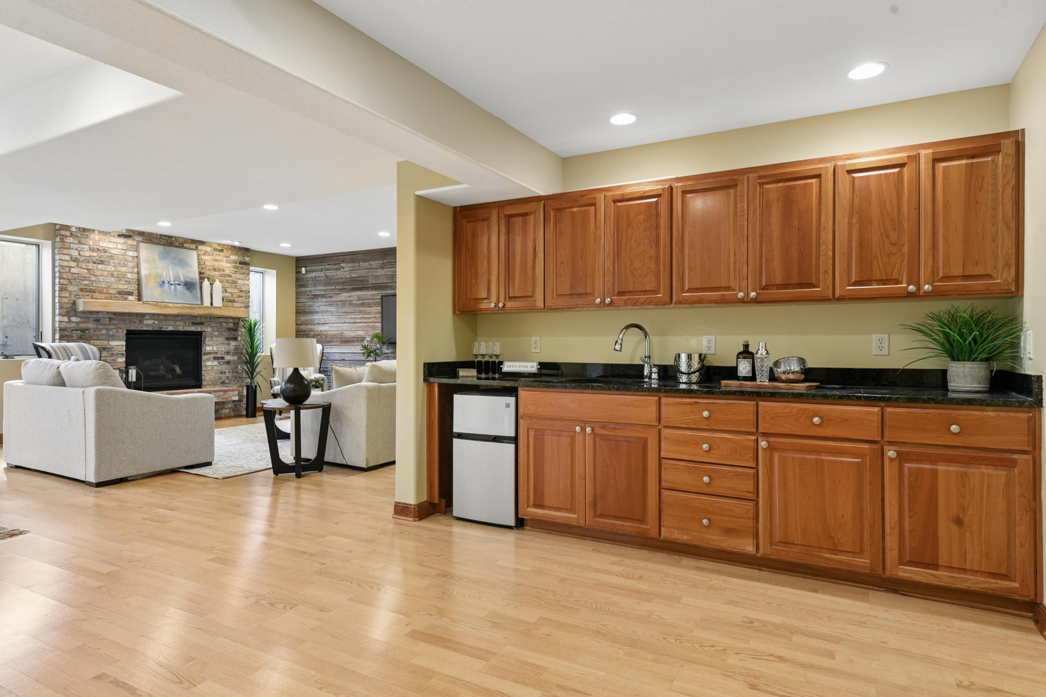 Entertaining wet bar complete with mini fridge and abundant storage