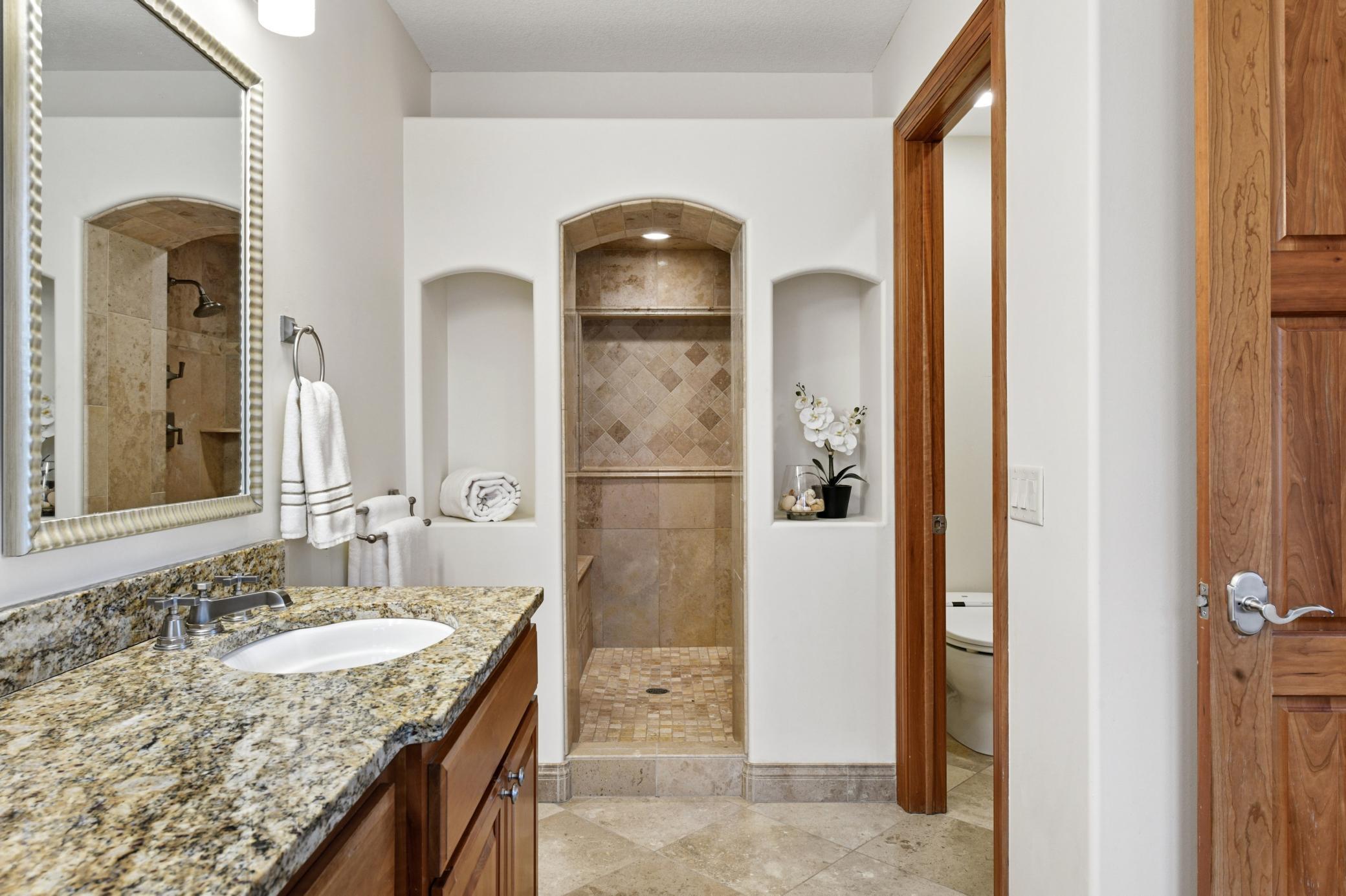 A serene spa shower experience with a heated bench