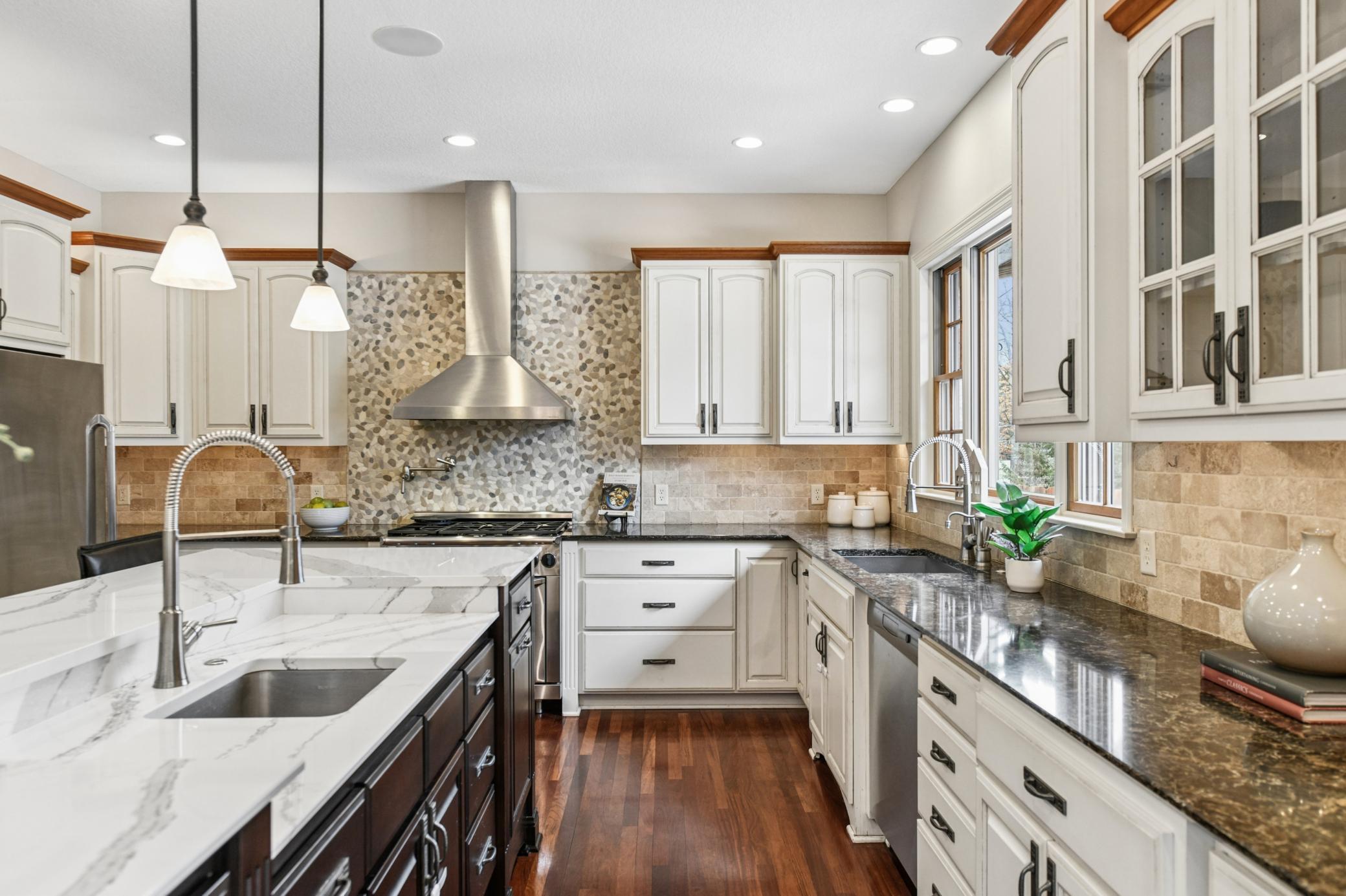 Additional features include a second sink, a Dacor wall oven and chef's gas stove and hood, with a wall mounted pot filler