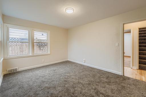 Actual picture of the second BR on the main level with newly installed carpet