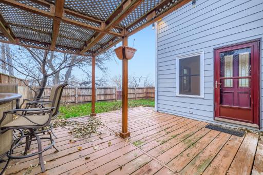 This door that leads off the main floor family room opens up to this great outdoor area with a fenced in backyard, privacy fence, and deck with pergola. Outdoor space for all your entertaining needs