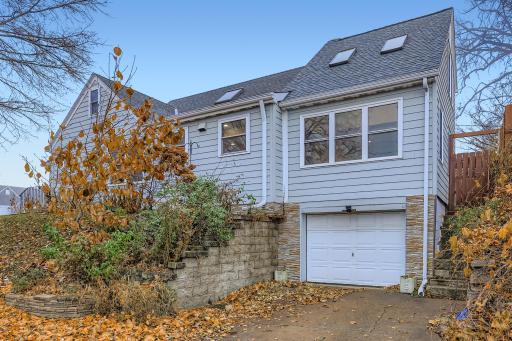 1 Car tuck under garage with steps on the side that lead up to the backyard area.