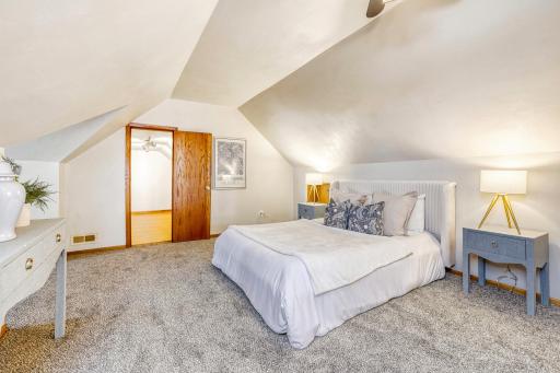 Upstairs is where this spacious primary bedroom is located with a huge walk in closet