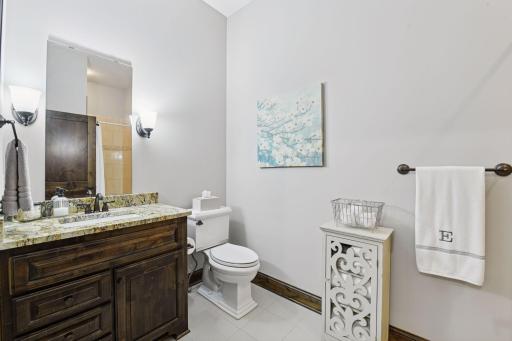 The private en suite bathroom features a furniture style-vanity and tiled flooring.