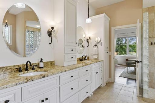 The Primary Suite features extensive custom cabinetry, heated tile flooring, and two walk-in closets.