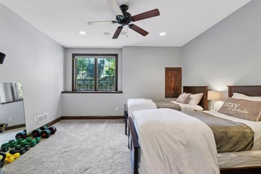 A large guest bedroom is housed in the lower level.