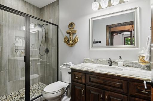 A 3/4 bathroom with radiant in-floor heat completes the lower level.