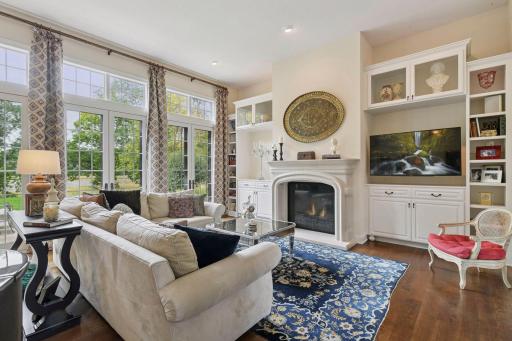 The spacious Family Room features a beautiful gas fireplace flanked by enameled built-ins.