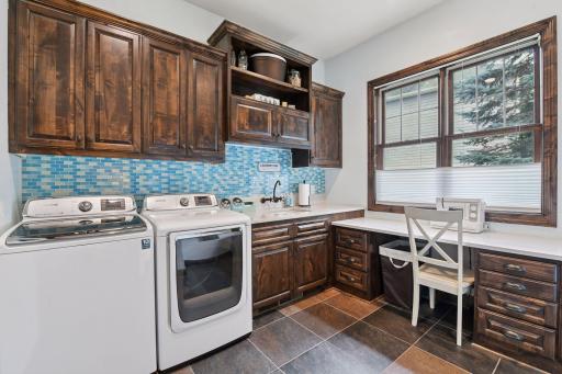 The Laundry Room is the workhorse of this floor plan with a built-in desk and ample cabinetry so you can craft or work on your hobbies easily.