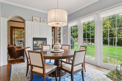 A gas fireplace creates a cozy atmosphere and beautiful windows offers views of the private backyard.