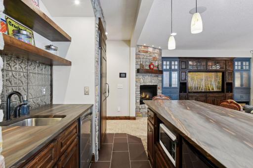 The bar offers sueded granite countertops, a built-in refrigerator, dishwasher and mini freezer. The tile floor provides radiant in-floor heat keeping your toes warm all year long.