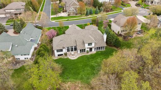 Enjoy this tranquil setting surrounded by mature trees, beautiful landscaping and backing to Lake Harrison.