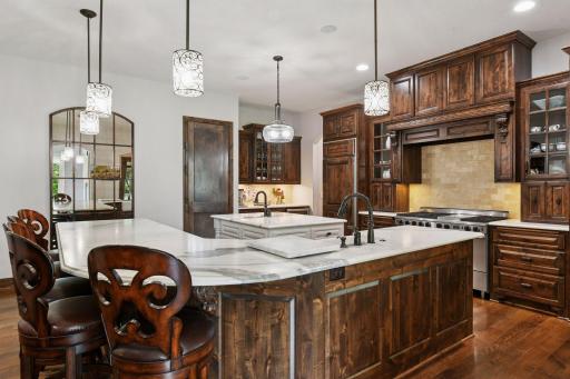 The kitchen is well-equipped with professional appliances including a 48" FiveStar gas range with double ovens, built-in Northland refrigerator and separate freezer, and new KitchenAid dishwasher.