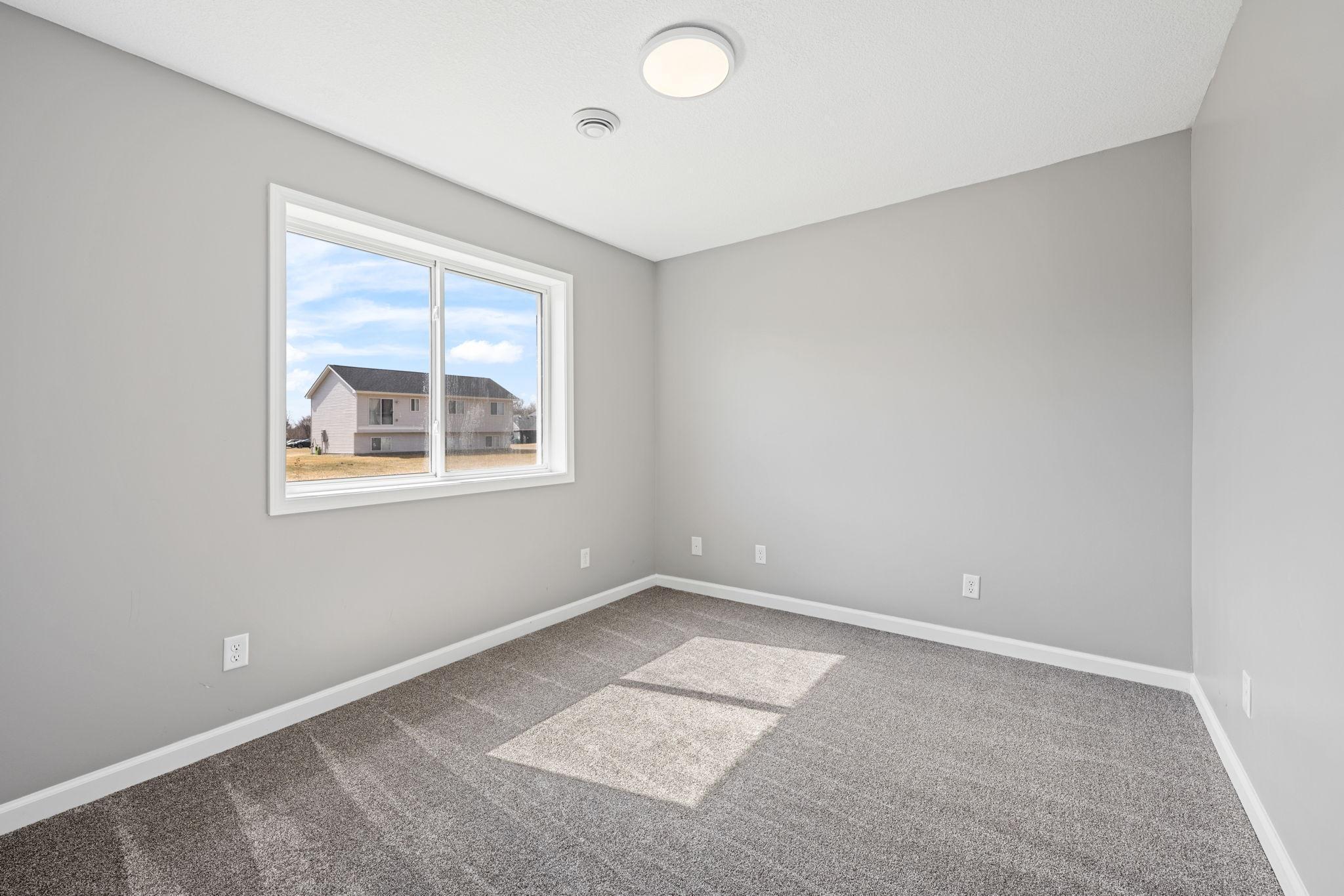 Lower level bedroom ideal for a home office or guest space.