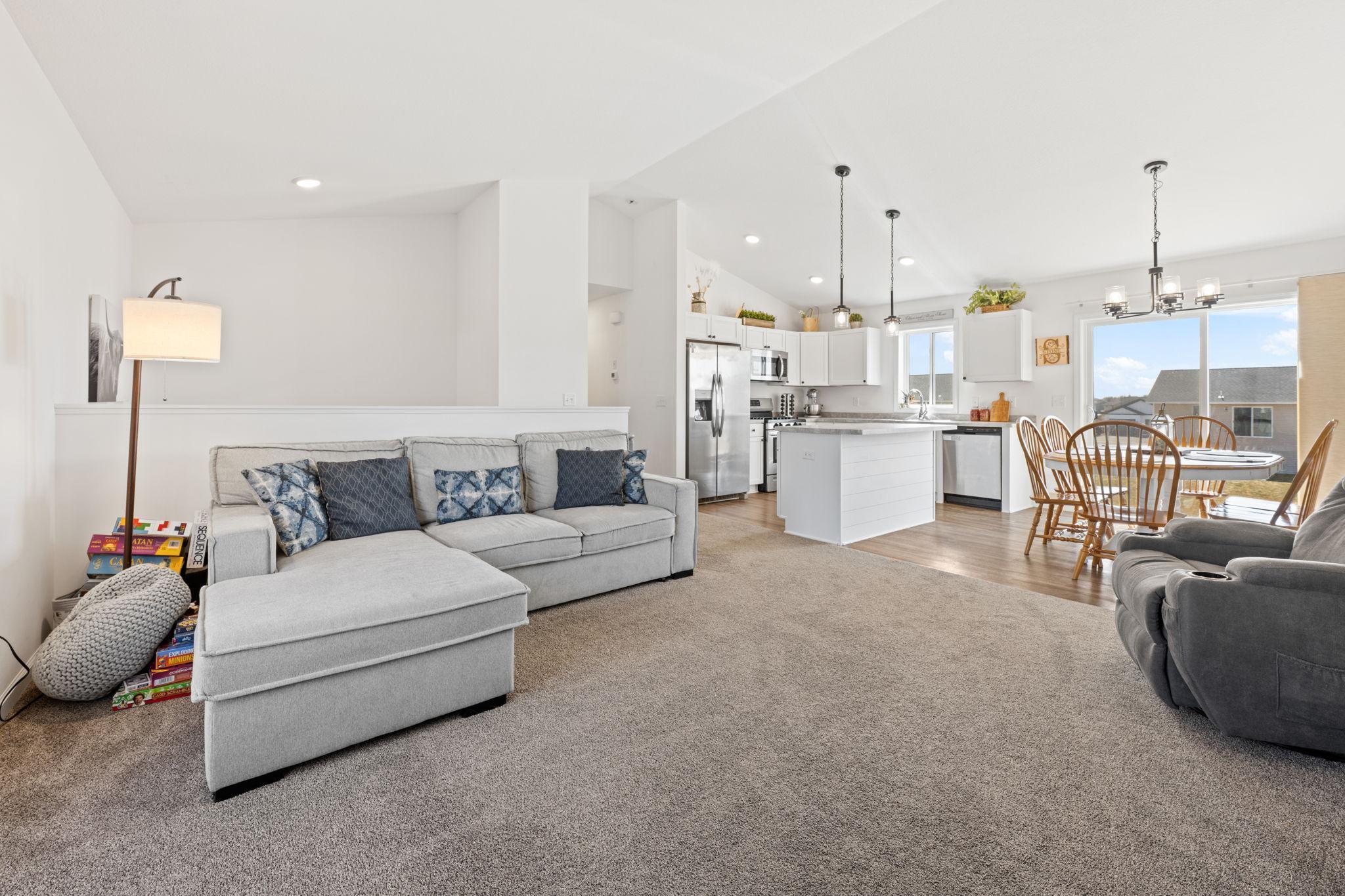 The open-concept main level is filled with natural light and highlighted by vaulted ceilings creating a bright and airy feel throughout.