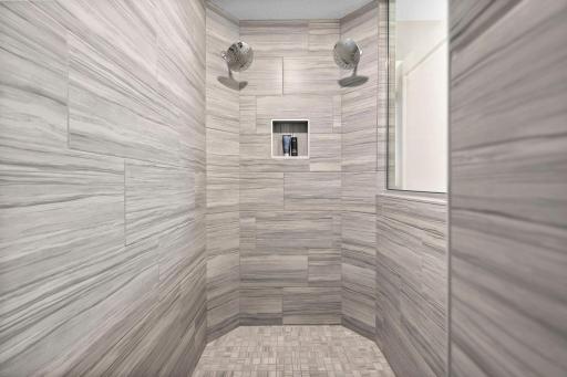 Two shower heads and gorgeous tilework in the primary shower!