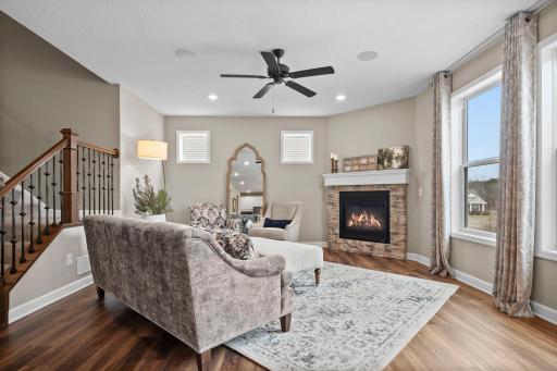 The living room has a gas fireplace with brick surround.