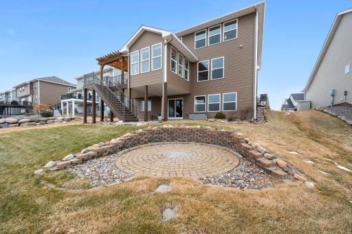 The yard has been beautifully landscaped with a fire pit area and retaining wall.