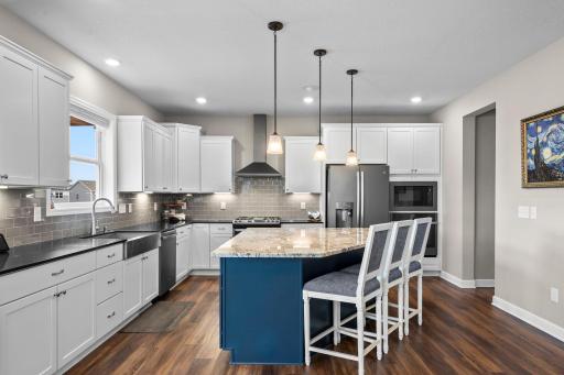 The kitchen features an oversized center island with room for seating.