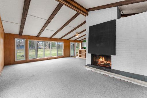 Towering vaults, wood beams! Wood burning fireplace accent by brick.