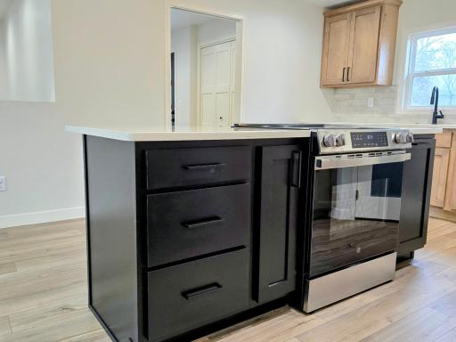 Center island has storage with brand new stove