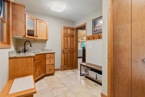 Spacious entry and mudroom with granite countertops