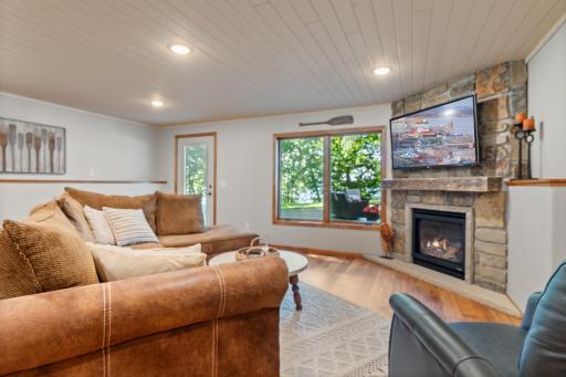 Cozy gas fireplace with natural stone was recently installed in the lower level family room