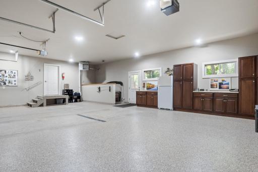 Heated 3 stall garage with epoxy flooring and built in cabinets and butcher block countertops