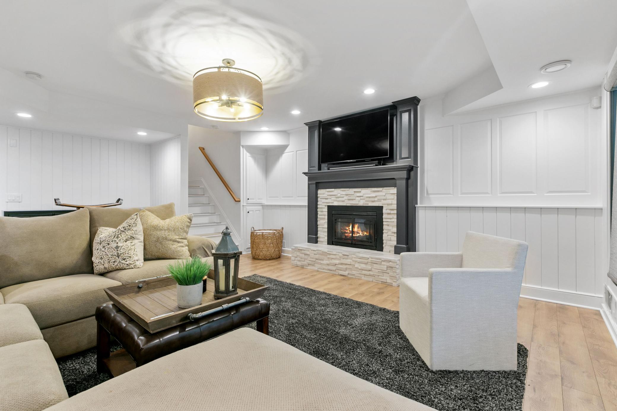 Stone faced gas fireplace warms the basement family room.