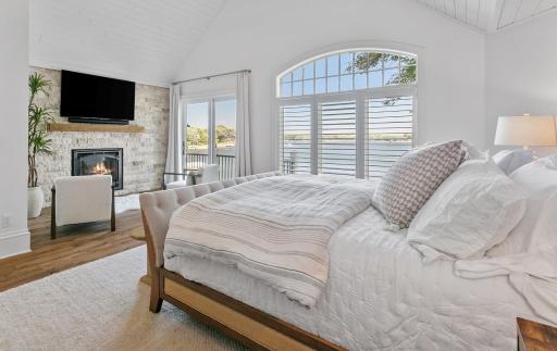 Primary bedroom anchored with a cozy gas fireplace and tucked away for privacy with it's own walk out to the deck. Huge walk in closet closet with built in, shiplap, skylight and elegant wood flooring.