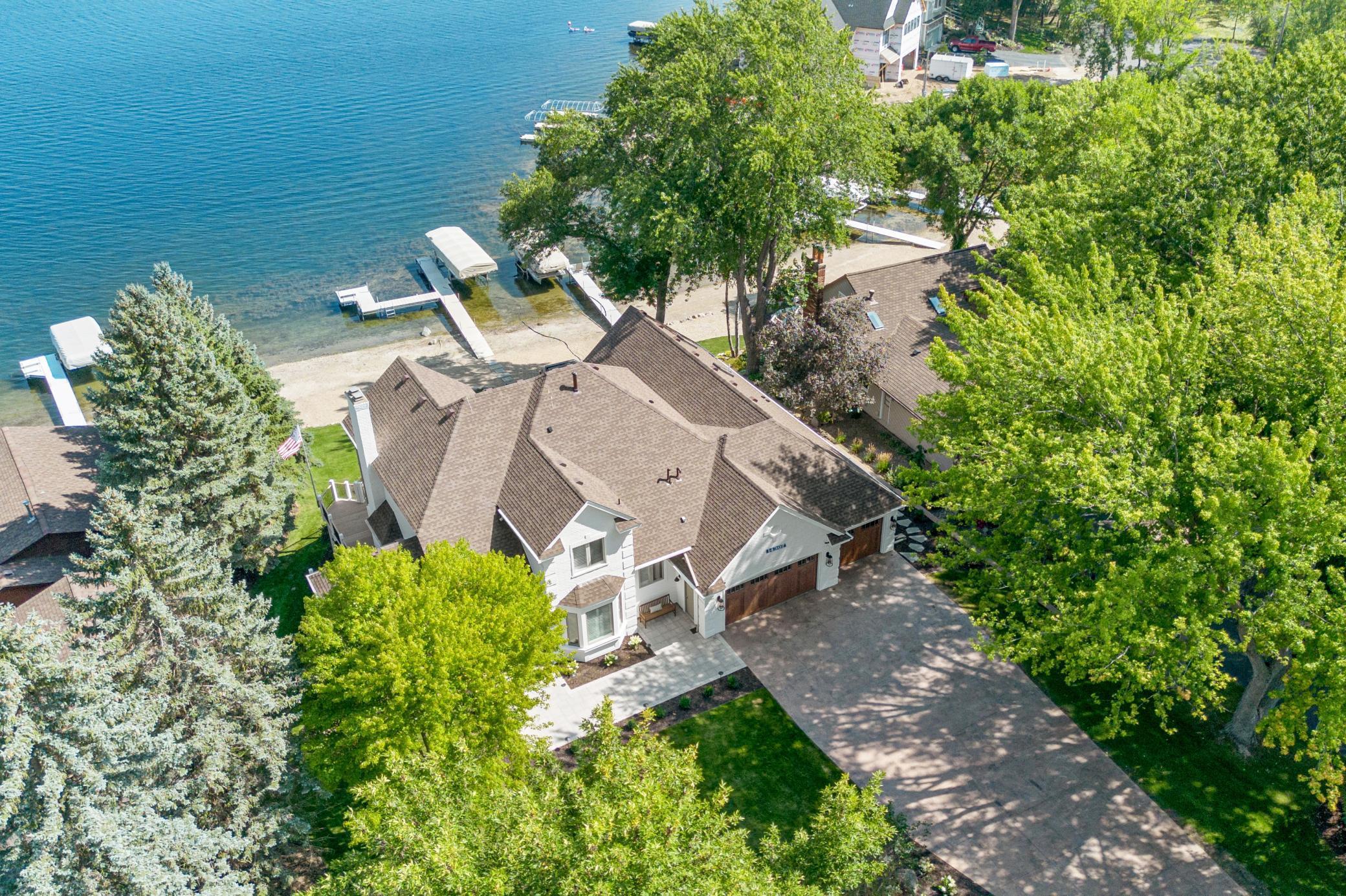 Surrounded by lush greenery, this private lakeside setting offers your own peaceful beach and backyard retreat.