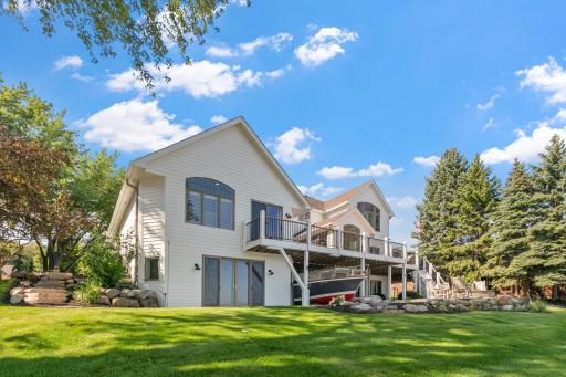 Enjoy multiple outdoor areas that make the backyard a perfect setting for gathering and unwinding by the water.