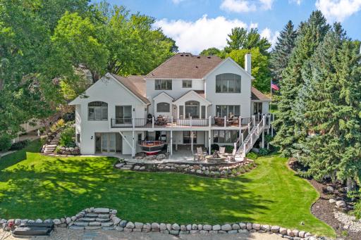 The back of the home is just as stunning, with beautiful architecture and outdoor spaces designed to enjoy the lake setting.